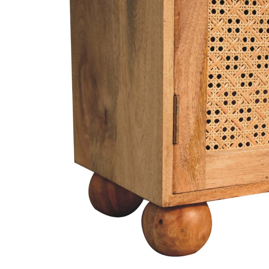 Wooden cabinet with ornate lattice work and round feet.
